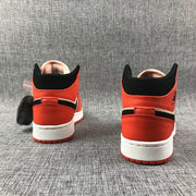 Jordan Air Jordan 1 Mid GS Sneakers in Pink and Orange